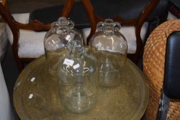 Three glass demijohns