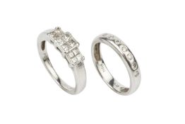 A diamond ring, set with three square panels of four princess cut stones, set in platinum to a plain