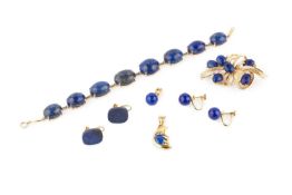 An 18ct gold and lapis lazuli bracelet, set with eight graduated oval cabocchon stones, the clasp
