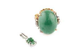A green stone and diamond dress ring, the oval cabochon green stone in pierced openwork mount, set