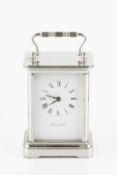 A silver plated carriage timepiece by Tiffany & Co, with white enamel dial and quartz movement,