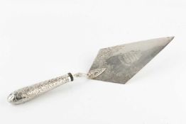 An early Victorian silver presentation trowel, the lozenge shaped blade engraved with foliage and