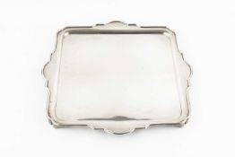 A George V silver square section salver, with shaped border, by Z. Barraclough & Sons, Sheffield