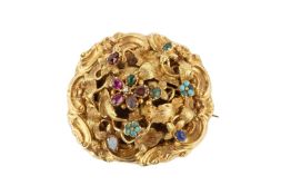 A yellow precious metal and gem set acrostic brooch, of shaped and domed cushion form, centred