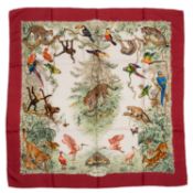 An ‘Equateur’ Hermès silk scarf, designed by Robert Dallet featuring wild and exotic animals, a