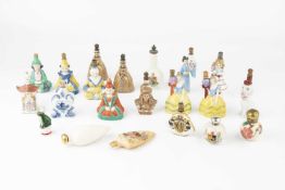 A collection of porcelain figural scent bottles, to include chinamen, elegant ladies, a seated