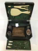 A late Victorian crocodile leather toilet box, the fitted interior containing a range of silver