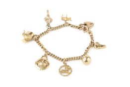A 9ct gold curb link charm bracelet, with padlock clasp, hung with various 9ct gold charms, clasp