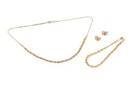 A pair of diamond ear studs, each channel-set with small baguette cut stones in unmarked yellow