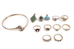 A 9ct gold bangle, the terminals set with oval cut amethysts, 6.8cm wide, together with eight