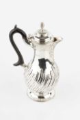 A late Victorian silver hot water pot, of spirally lobed baluster form, with ebonised handle, by