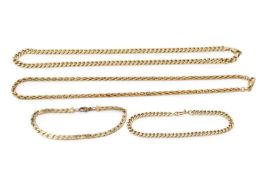 A yellow metal curb link necklace, 42cm long, another similar of multi-link design, and two