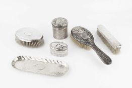 An Edwardian silver cylindrical box and cover, and a matching silver backed hairbrush, repoussé