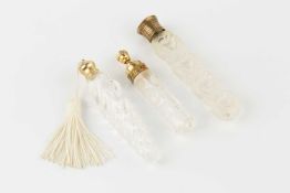A vintage Lalique 'four hearts' glass scent bottle, for Nina Ricci, 9.5cm high, and two further