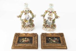 A pair of late 19th century German porcelain figural candlesticks, each modelled with a figure