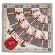 A 'Cliquetis' silk scarf by Hermès, designed by J. Abadie, decorated in shades of grey, taupe and