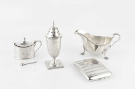 A silver sauce boat, with gadrooned border, leaf capped handle and scalloped feet by Adie Bros,