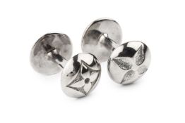 A pair of silver cufflinks by Louis Vuitton, of curved form, the rounded ends with flowerhead and LV