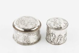 A late 19th century Dutch silver cylindrical box and cover, repoussé decorated with a country