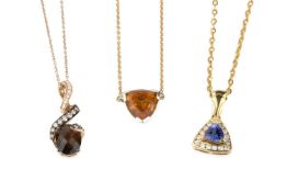 A 14k gold and diamond pendant by Le Vian, of open twist design, and set below with an oval cut