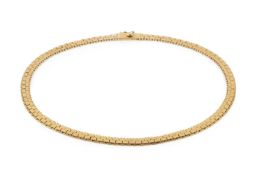 An 18ct gold necklace, composed of flattened brick links, the clasp stamped 750, 37.5cm long