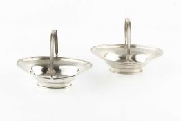 A pair of George III silver swing handled oval dishes, with reeded borders and a band of chequer