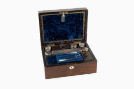 A Victorian rosewood toilet box, the fitted interior containing a range of bottles and jars with