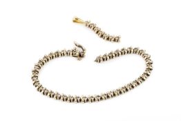 An 18k gold and diamond line bracelet, set with forty-nine brilliant cut stones, stamped Iliana 18k,