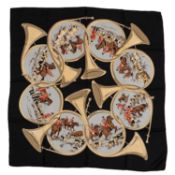 A Hermès silk scarf depicting interlocking horns, and hunting scenes with men in their attire,