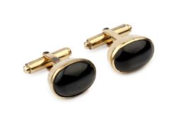A pair of star diopside cufflinks, the oval cabochon stones in unmarked yellow metal mounts, 1.7cm