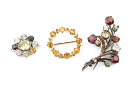 A 9ct gold and citrine circlet brooch, of wreath design, 2.6cm wide, a multi-coloured gem set floral