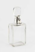 An Edwardian silver mounted locking decanter by Hukin & Heath, of rectangular form, with faceted
