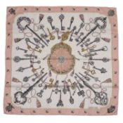 A 'Les Clefs' silk scarf by Hermès, designed by Cathy Latham, decorated with keys in pale pink and