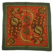 A 'Skyros’ Hermès silk scarf, designed by Julia Abadie in shades of orange, red, green and brown