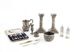 A pair of Edwardian silver candlesticks, of corinthian column form, on weighted gadrooned and