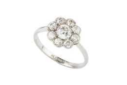 A diamond cluster ring, of flowerhead design, the central round brilliant-cut stone within a