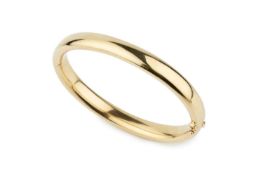 A French yellow gold oval hinged bangle, of plain design, 6.8cm wide Approx 25g Bangle appears to be