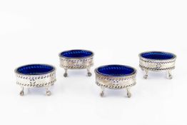 A set of four Edwardian silver oval salts, of Georgian design, with beaded borders, pierced and
