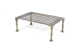 A 19th century steel and brass kitchen trivet. With four shaped brass supports.
