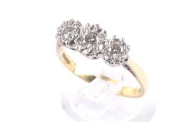 A vintage 18ct gold and diamond three stone illusion ring.