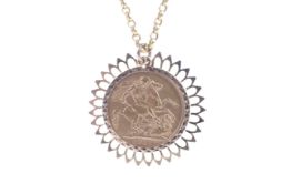 A sovereign, 1911, loosely mounted in a later 9ct gold pendant mount. On a belcher chain, 16.
