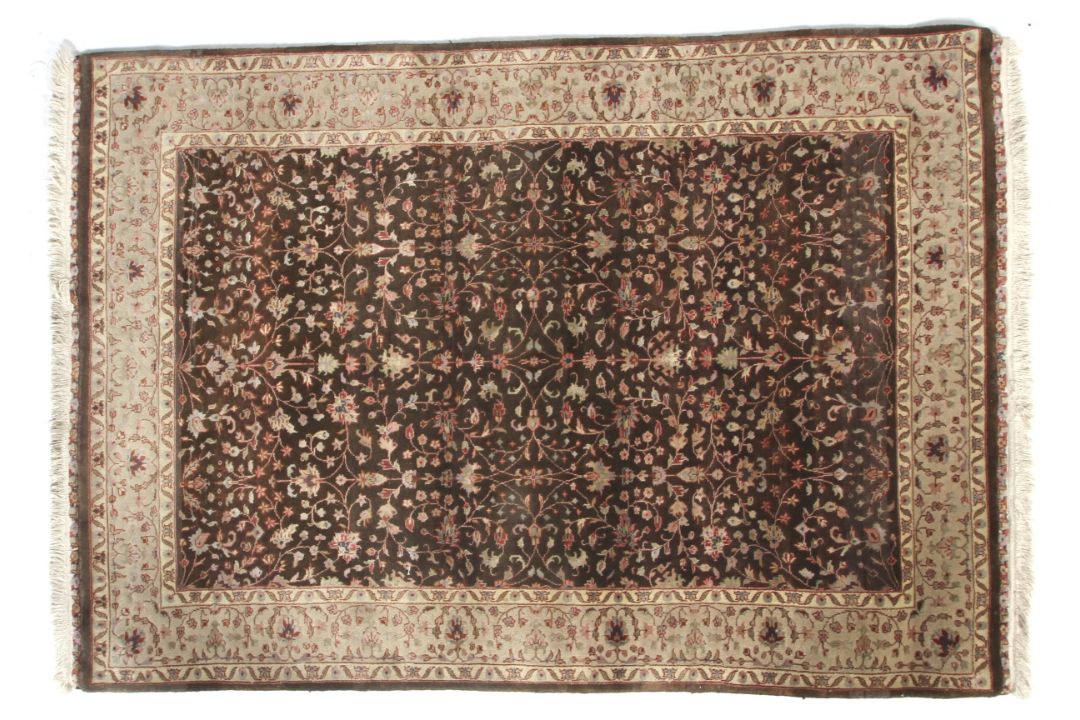 A brown ground rug with cream decoration. - Image 1 of 3