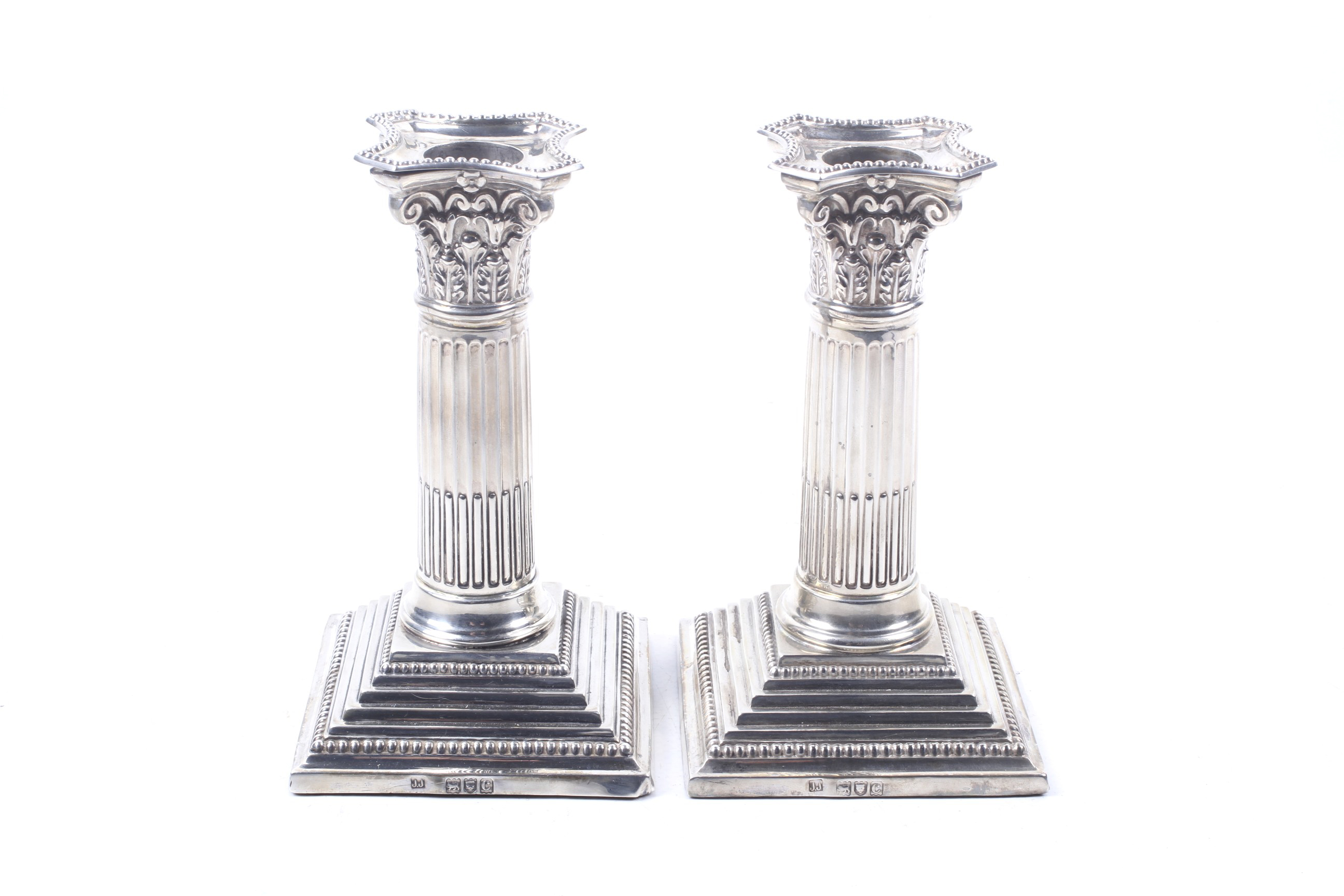 A pair of late Victorian square based candlesticks.