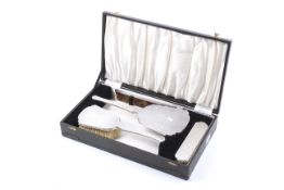 A silver mounted four piece dressing table set.
