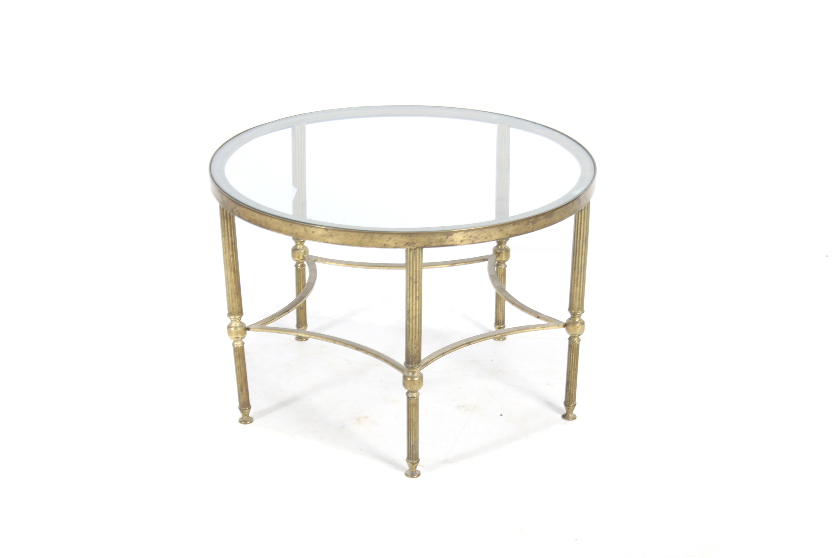 A circa 1970s round brass coffee table with glass top.