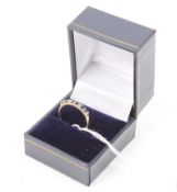 A yellow metal, sapphire and diamond half eternity ring. The band stamped '585', 1.