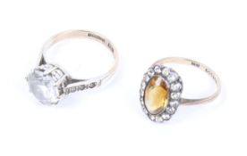 A 9ct gold and round-faceted paste single stone ring and a citrine ring.