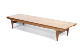 A mid-century teak base rectangular coffee table.