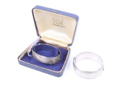 Two silver hinged bangles.