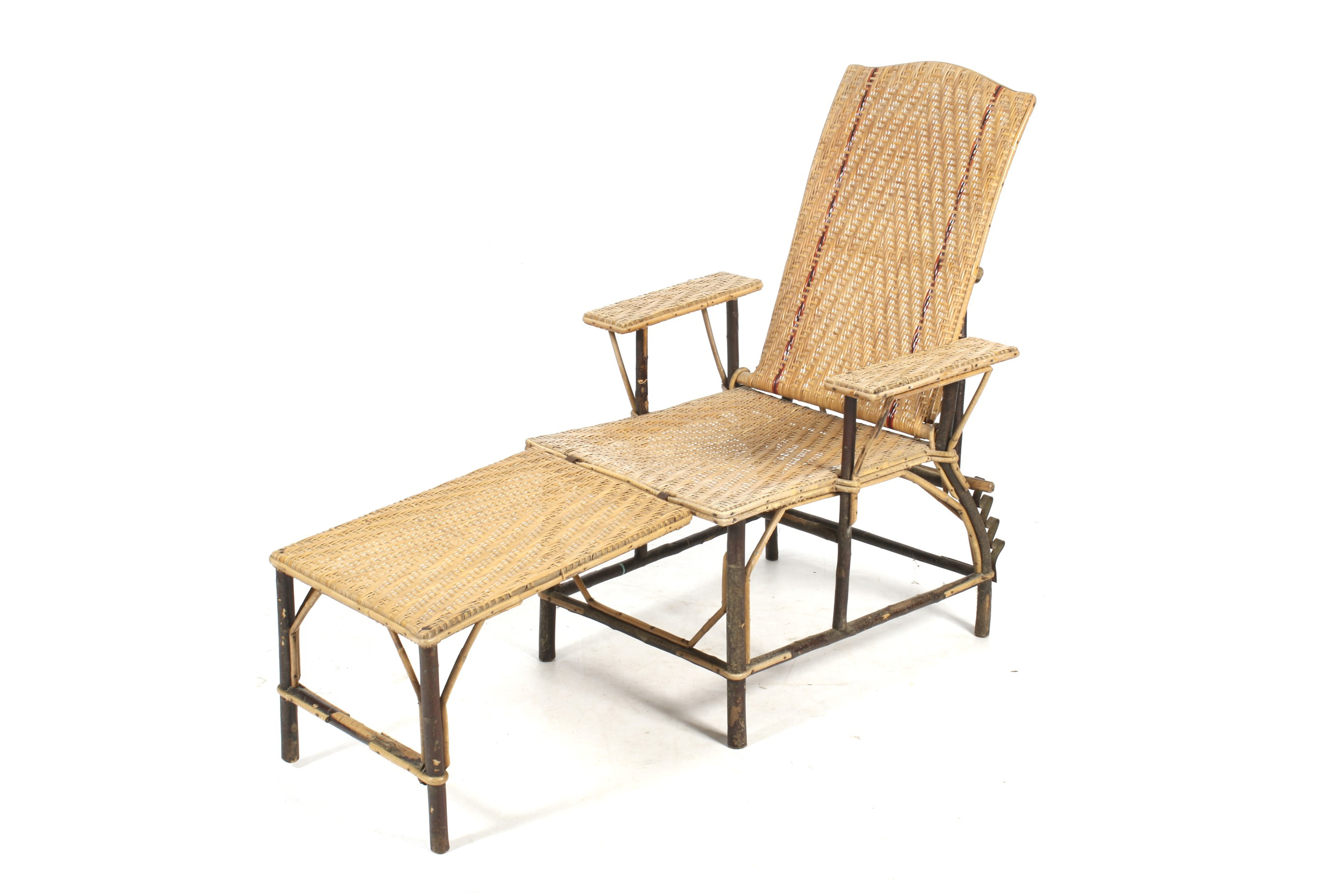 A mid-century plantation style rattan and beech branch framed lounger chair.